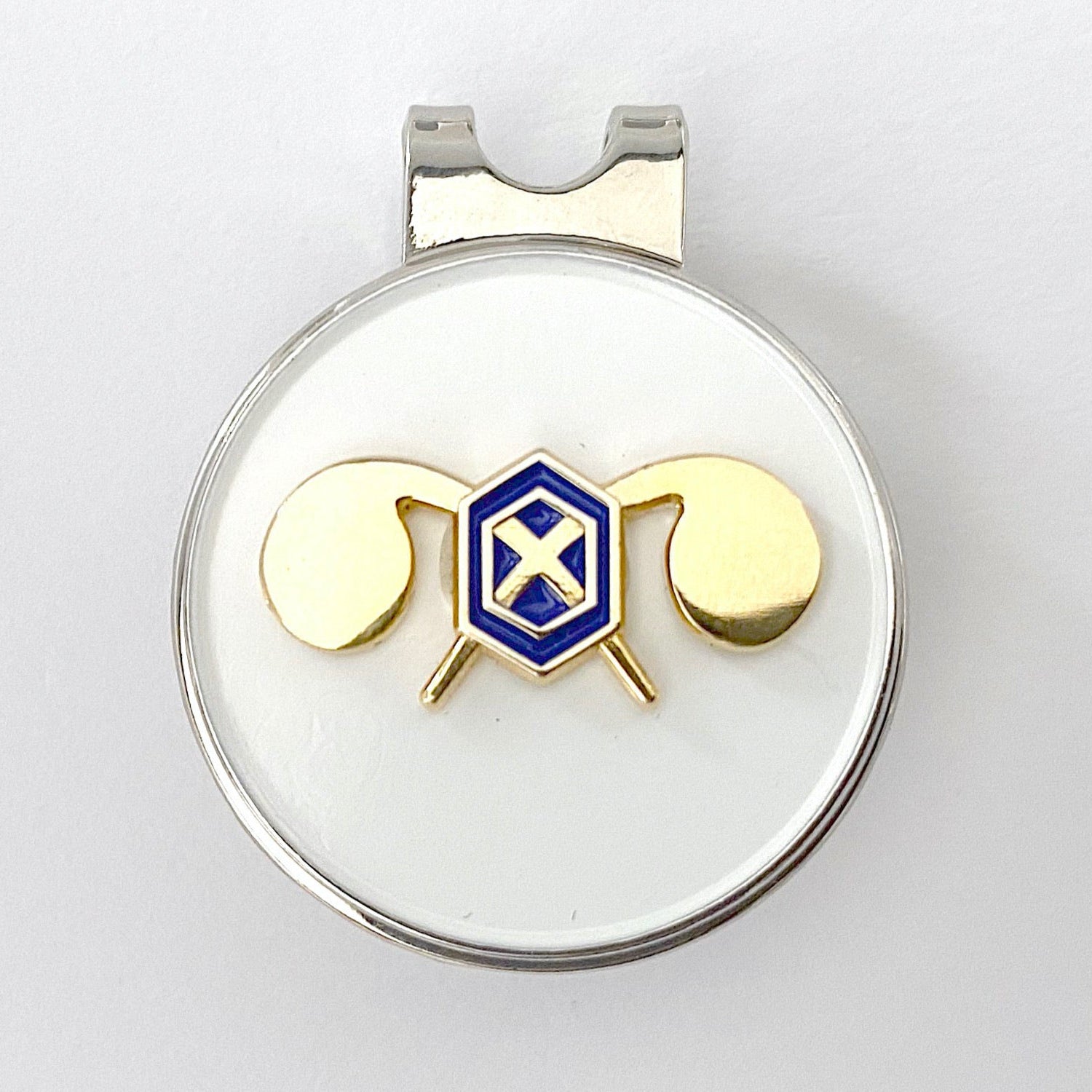 A gold-colored golf hat clip with a blue and yellow Chemical Corps branch insignia on a circular white background.