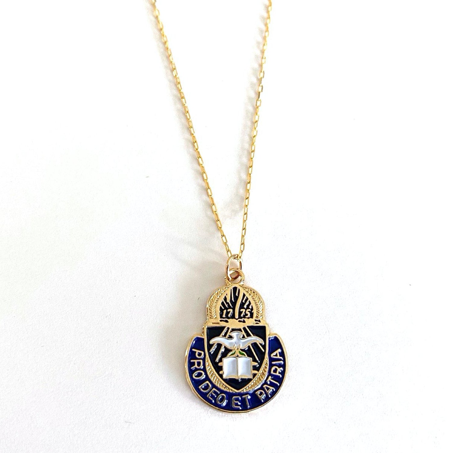 A gold-colored Chaplain Corps charm necklace with a blue and white enamel detail, displayed on a white background.