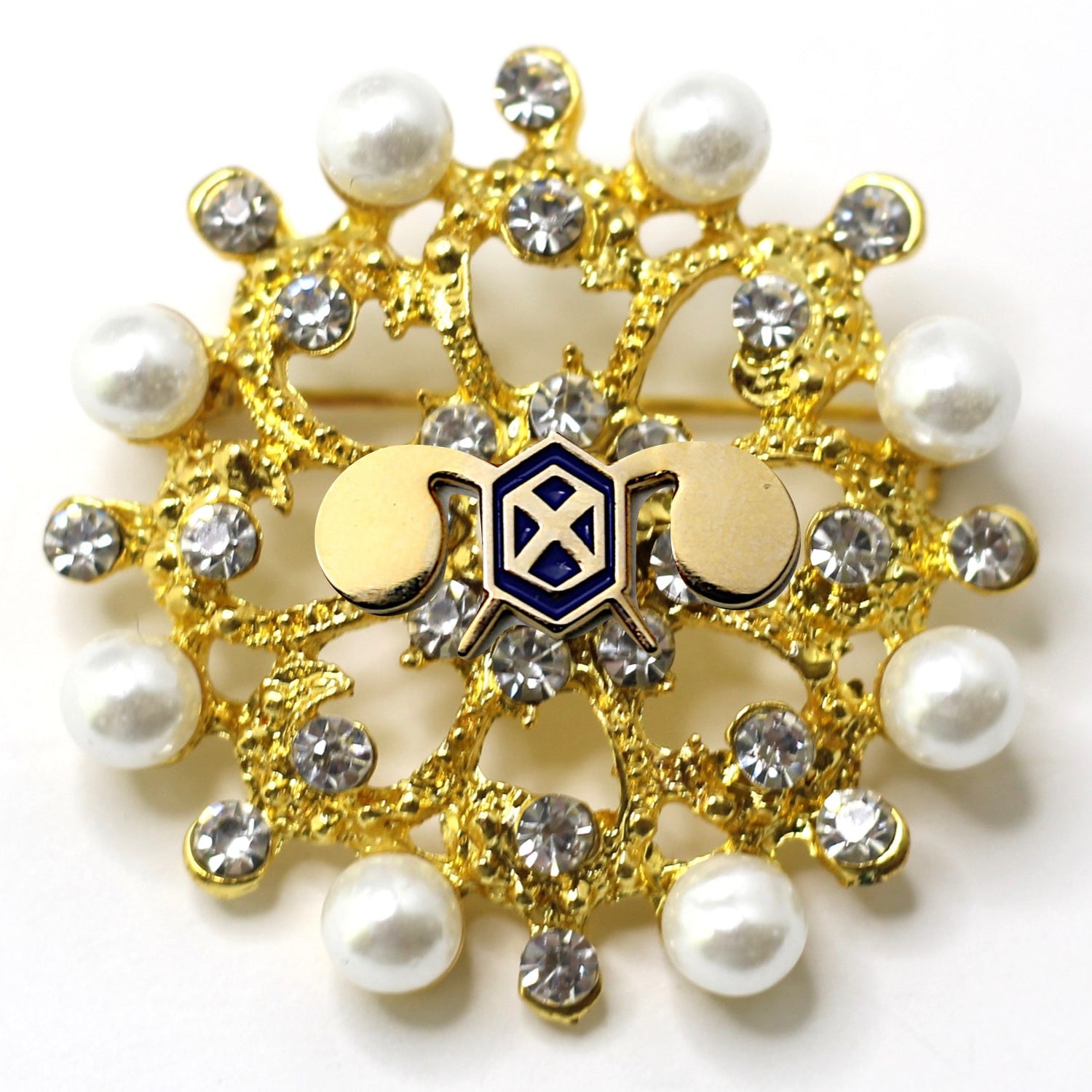 A gold-colored brooch with a U.S. Army Chemical Corps insignia centerpiece, adorned with white pearls and clear crystals.