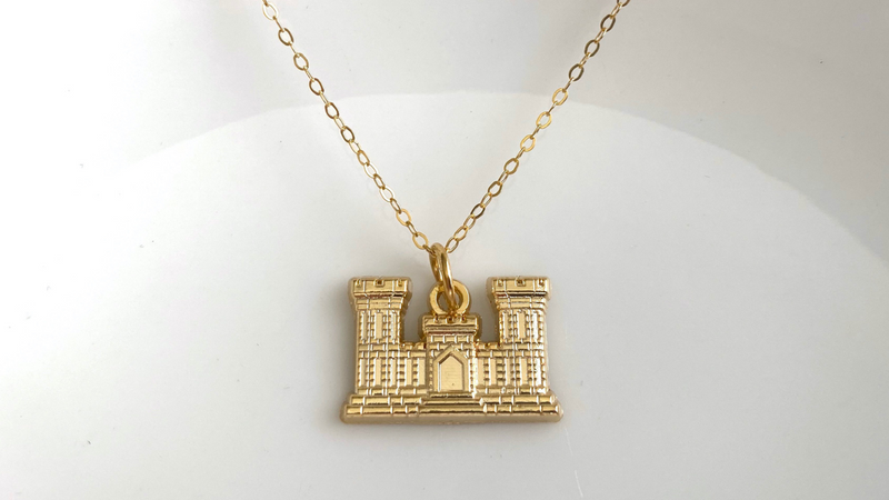 Gold Engineer Branch Insignia on a gold chain with a white background