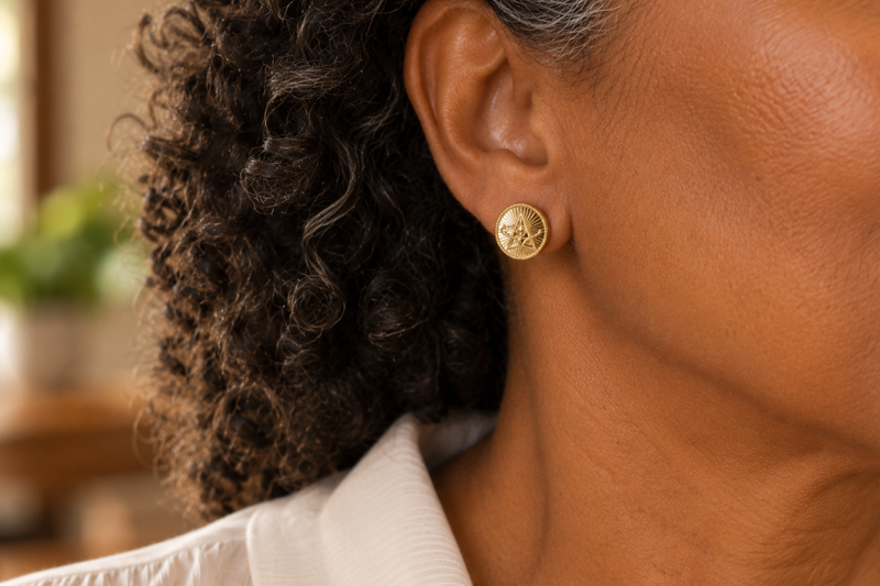 Pearl and silver earrings on white plate