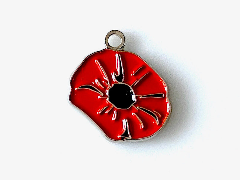 red poppy charm on a white background