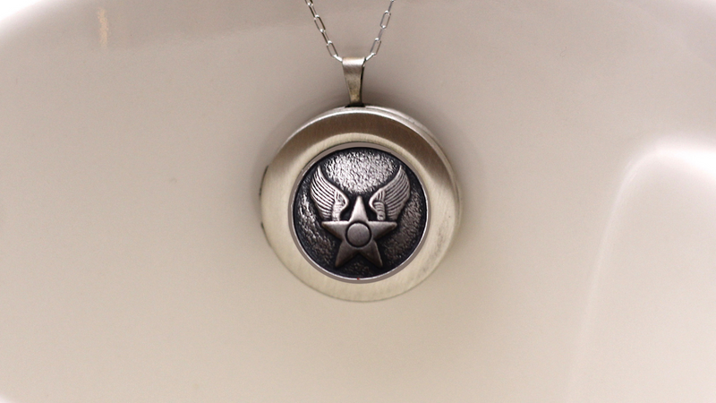 Silver Air Force Button locket on silver chain on white background