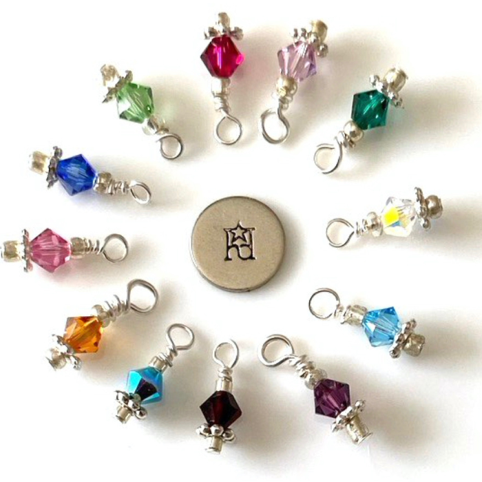Crystal charms in a variety of colors on a white background