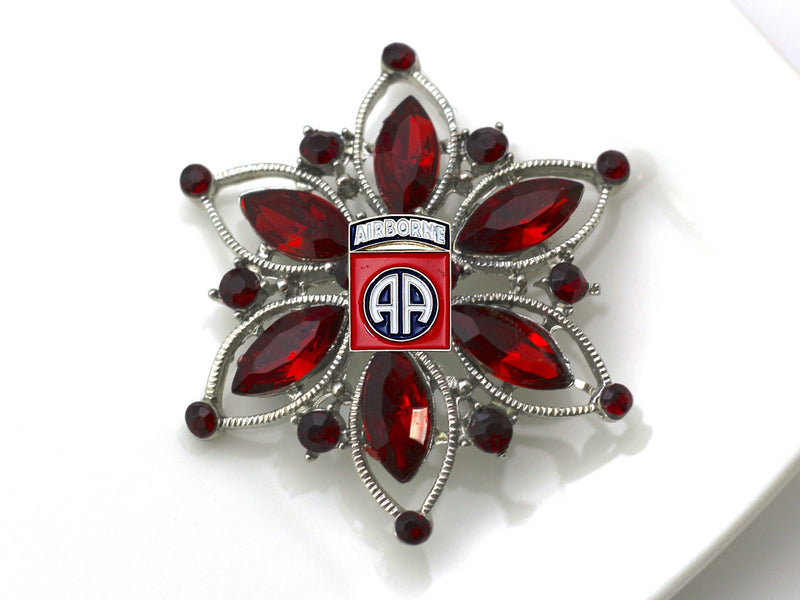 Red and Silver Brooch with 82nd Insignia on a white background