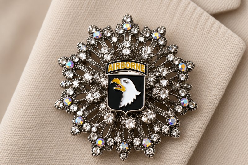 Black and Silver Brooch with Army Button center on white background