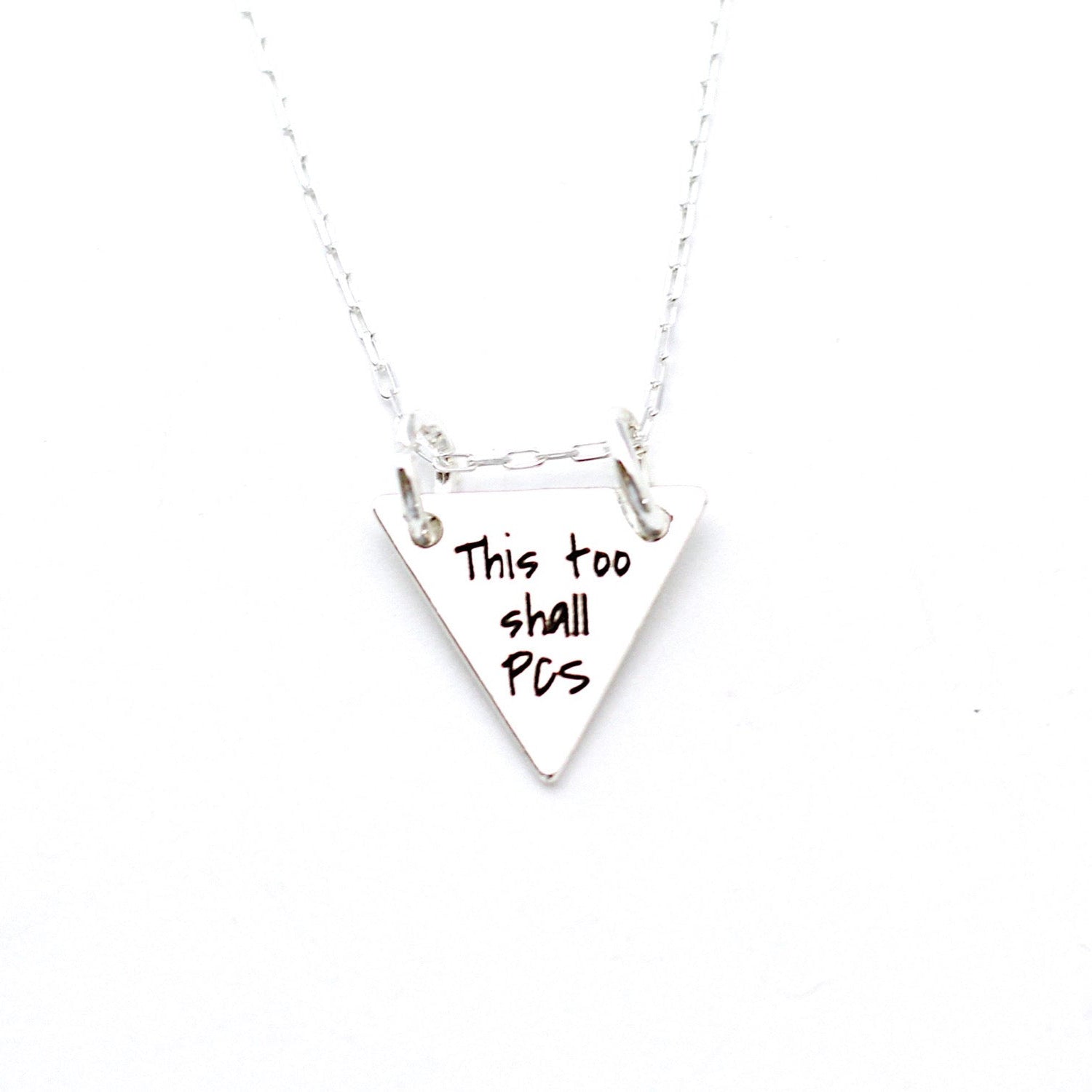 Silver necklace with a triangular pendant on a white background