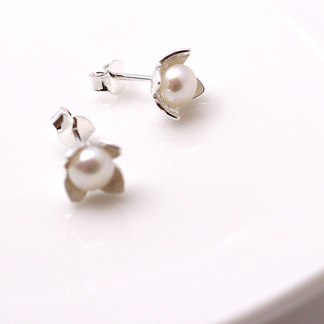 Pearl earrings on a white surface