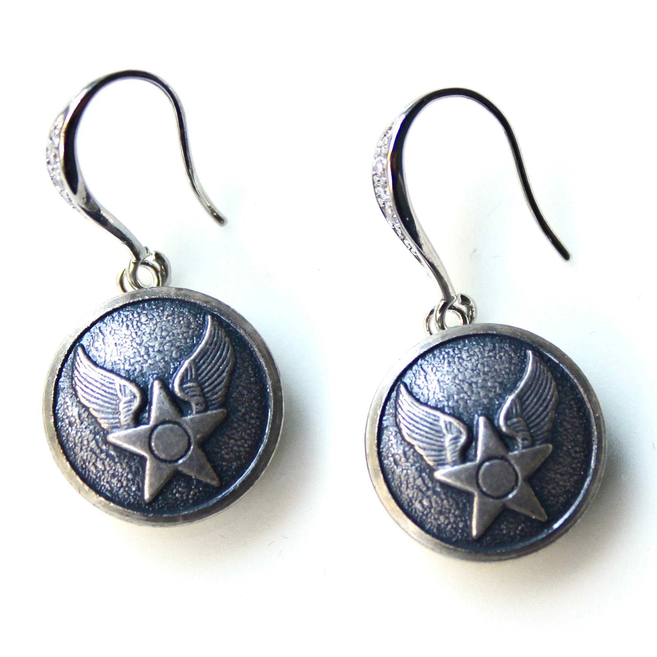 Pair of silver earrings with star and wing design on a white background