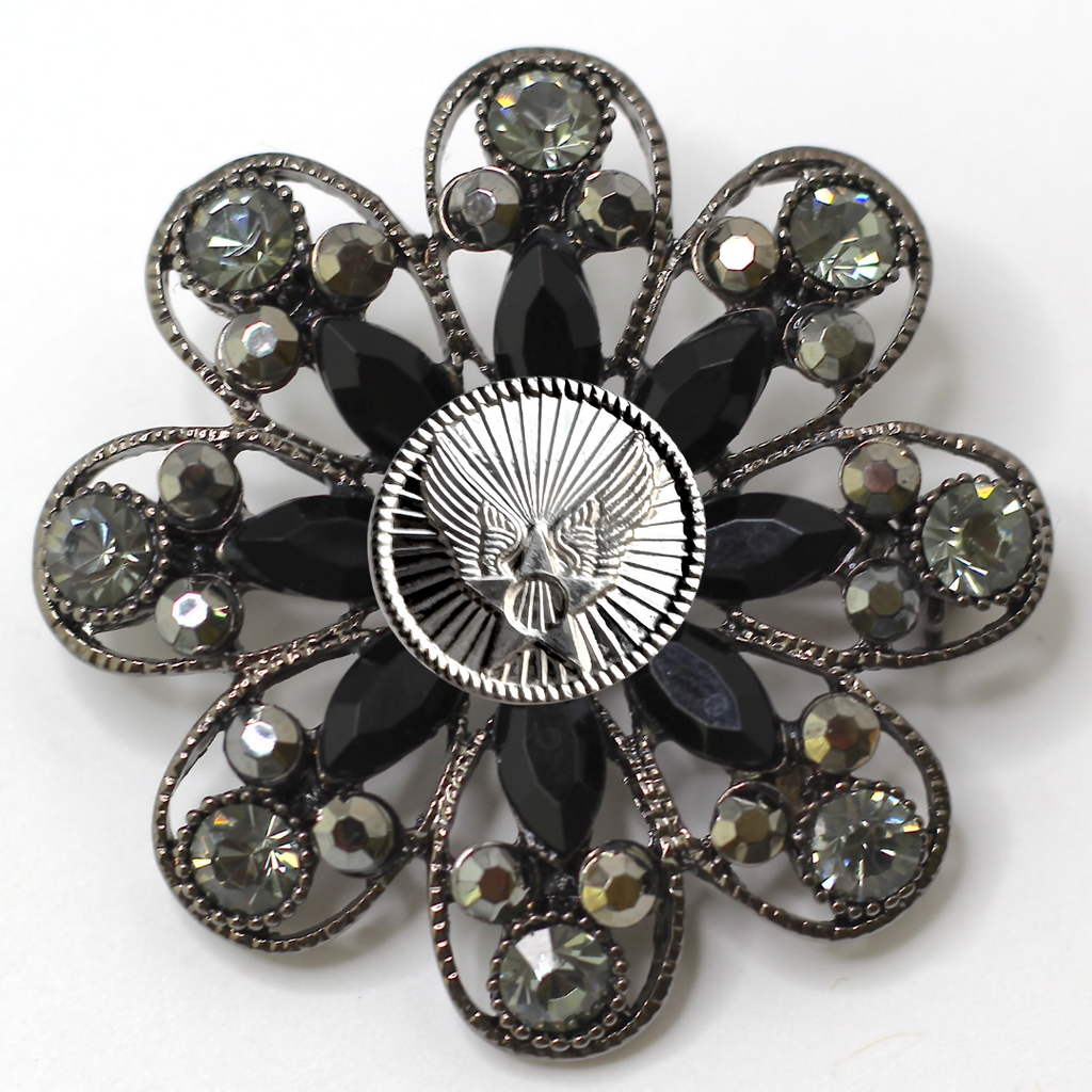 Decorative brooch with black gemstones and silver Air Force inspired centerpiece on a white background