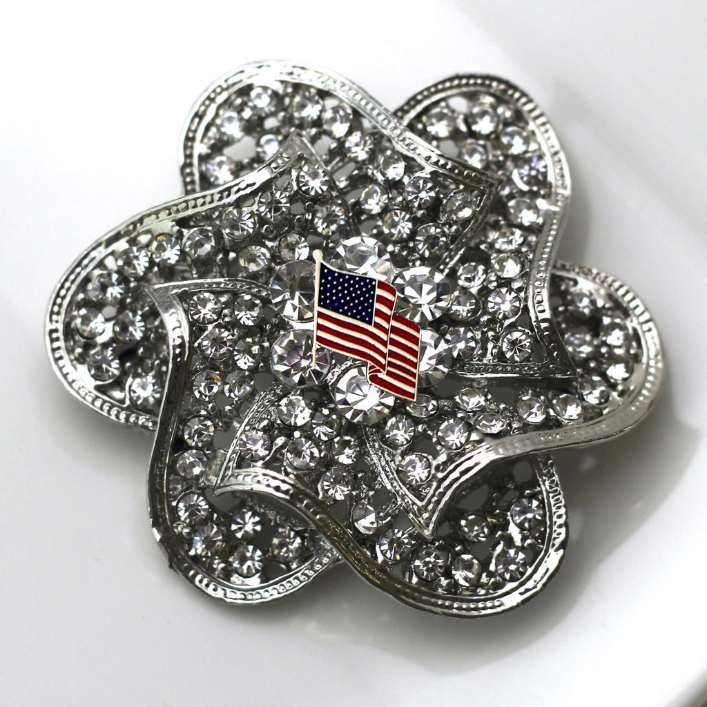 Silver four-leaf clover charm with American flag on a white background