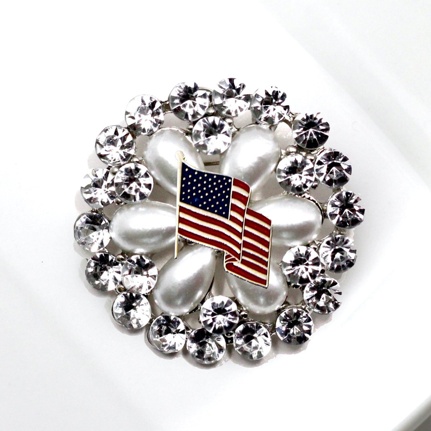 Decorative brooch with American flag design on a white background