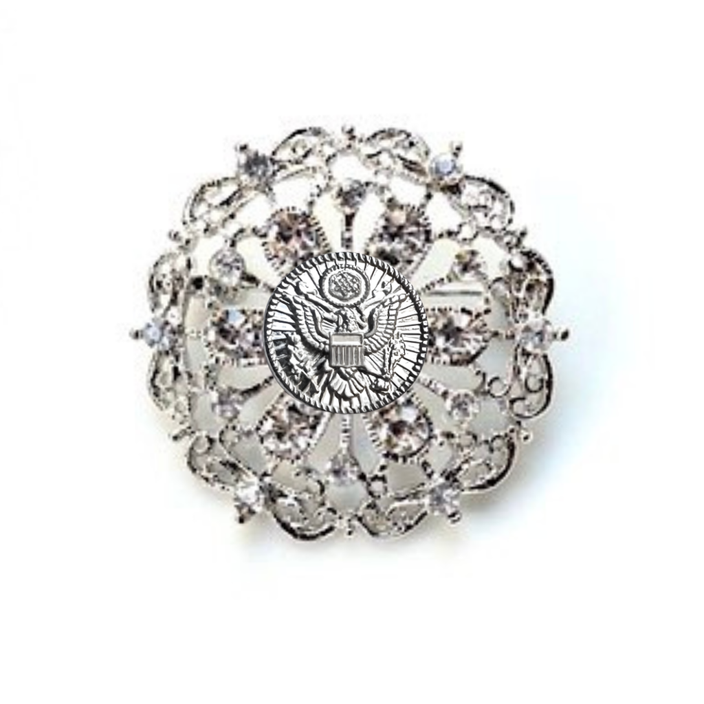 Decorative brooch with intricate design and central Army inspired emblem on a white background