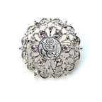 Decorative brooch with intricate design and central Army inspired emblem on a white background