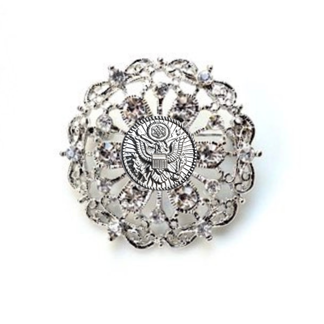 Decorative brooch with intricate design and central Army inspired emblem on a white background