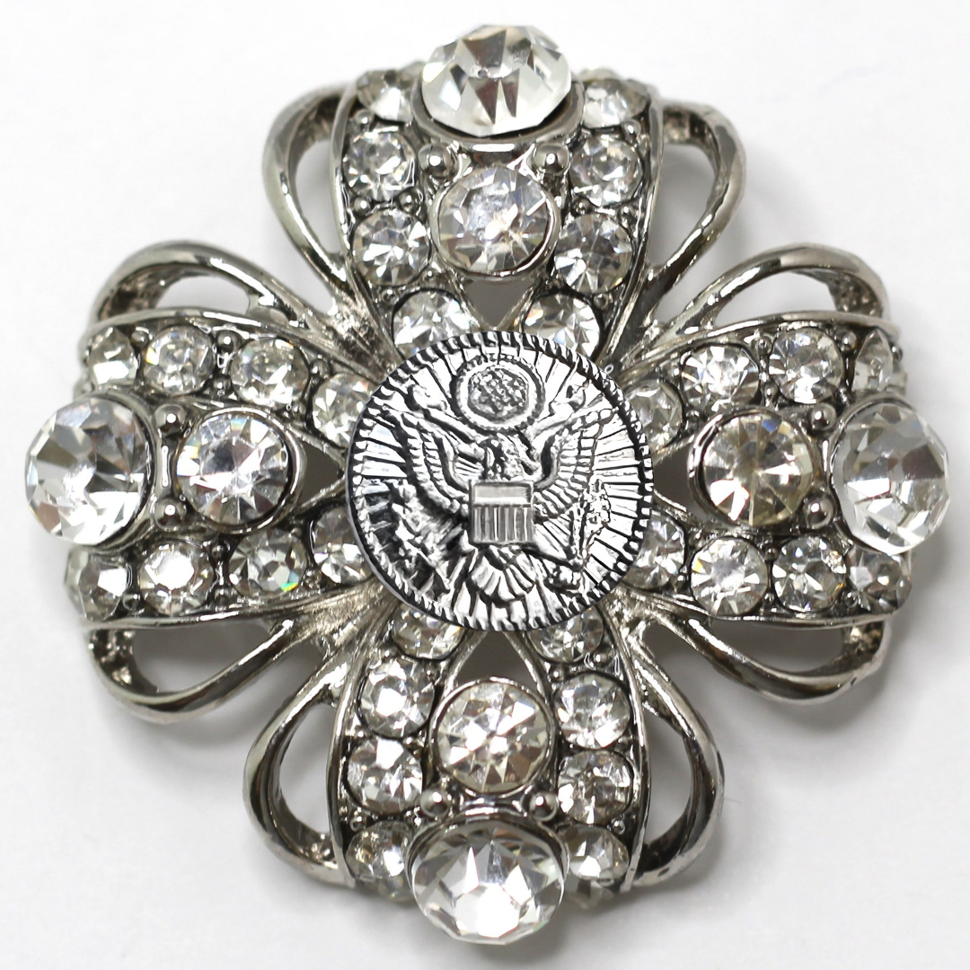 Decorative brooch with crystal-like stones on a white background