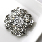 Decorative brooch with crystal details on a white background