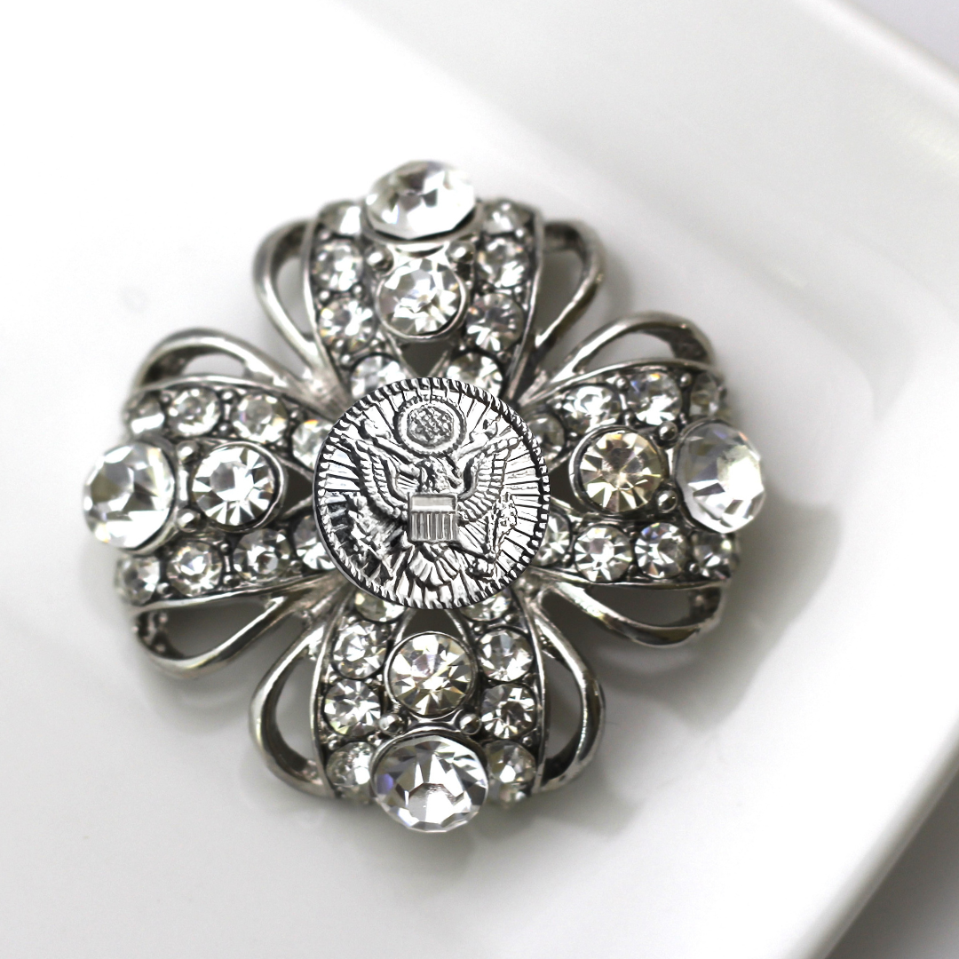 Decorative brooch with crystal details on a white background