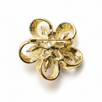 Gold four-leaf clover brooch on a white background