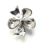 Silver four-leaf clover charm on a white background