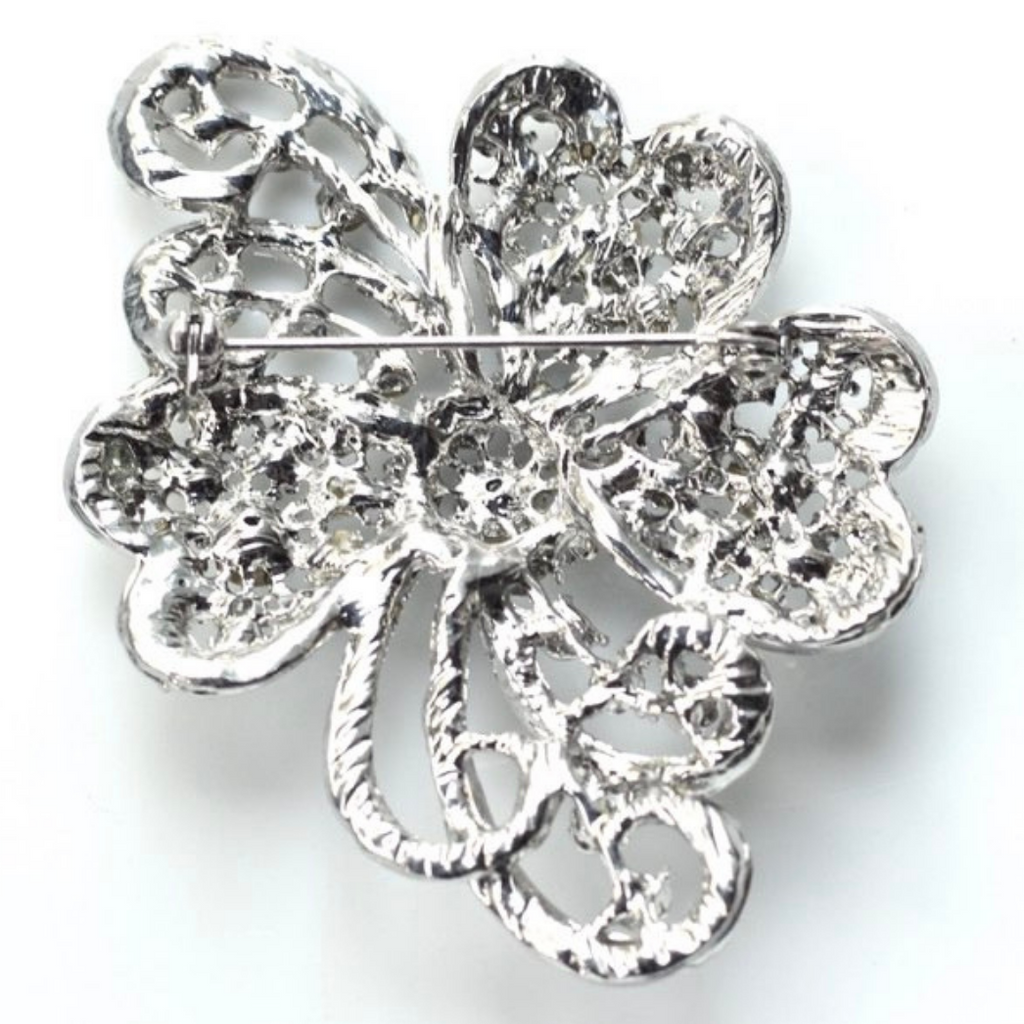 Silver four-leaf clover brooch on a white background