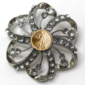Decorative brooch with crystal-like stones and a gold National Guard center on a white background