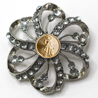 Decorative brooch with crystal-like stones and a gold National Guard center on a white background
