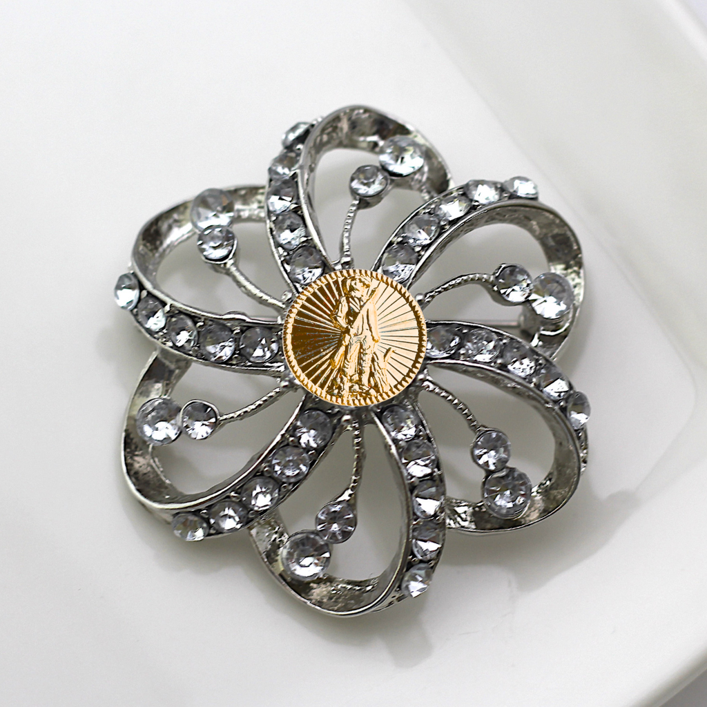 Decorative brooch with crystal-like stones and a gold National Guard center on a white background