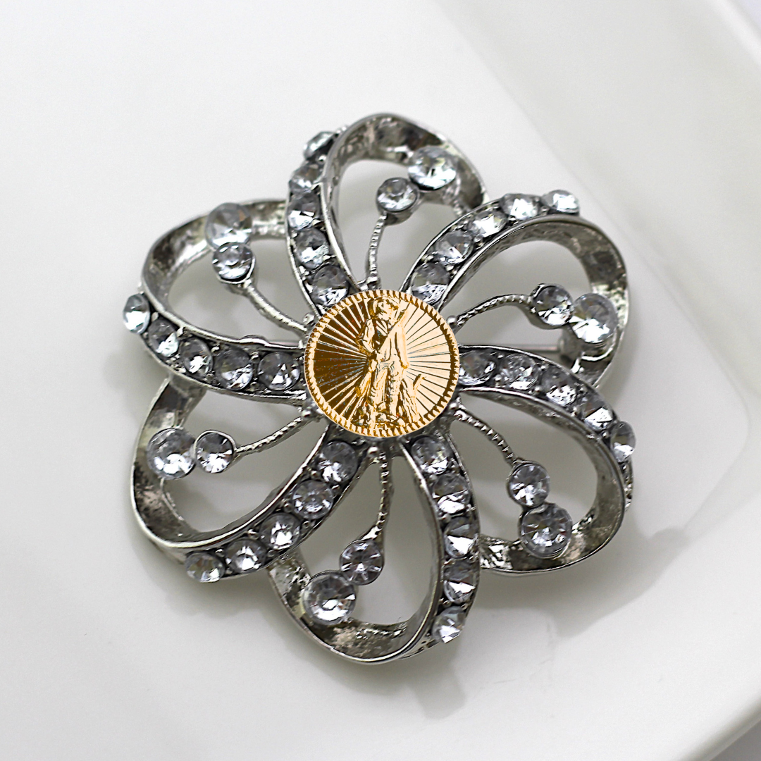 Decorative brooch with crystal-like stones and a gold National Guard center on a white background