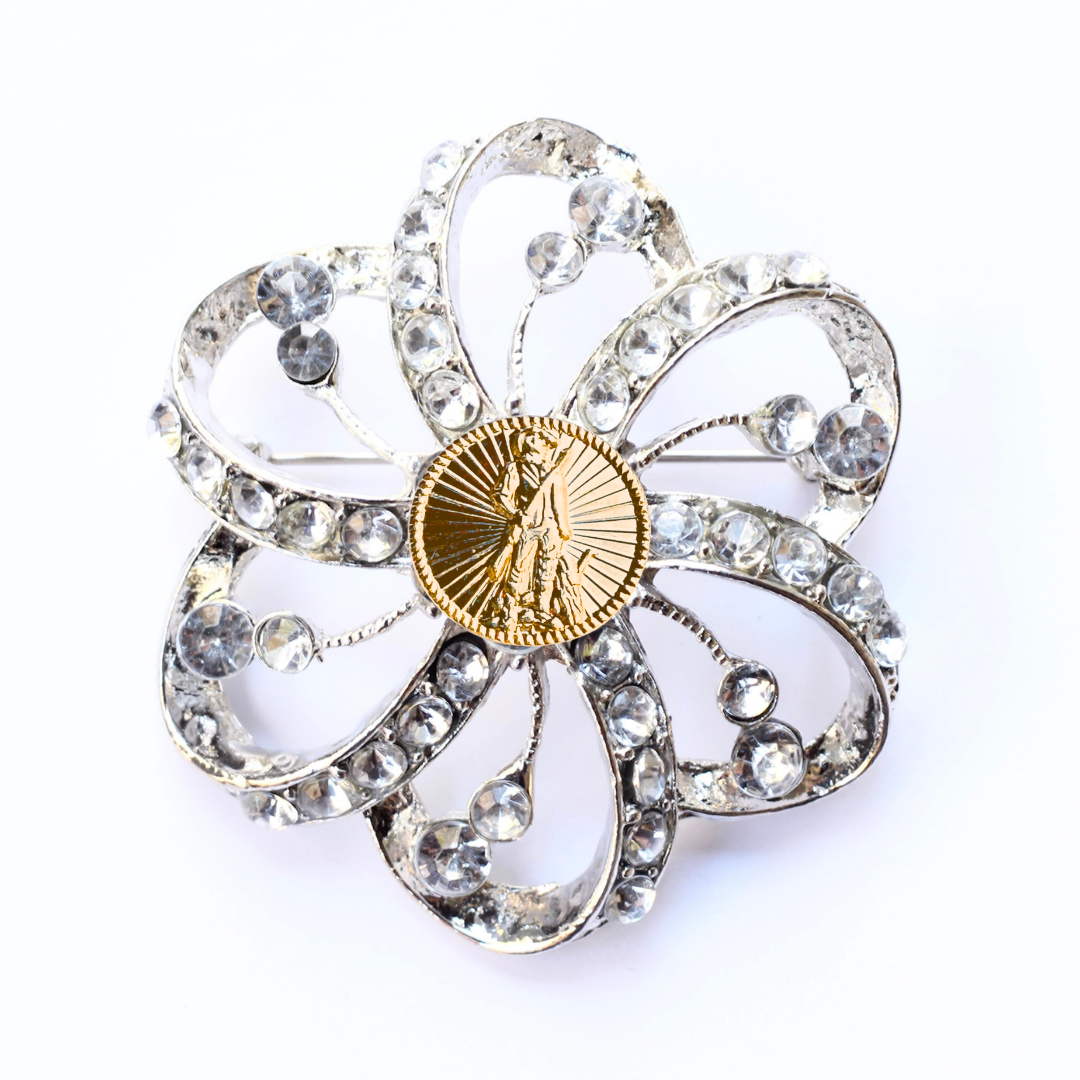 Decorative brooch with crystal-like stones and a gold National Guard center on a white background