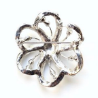 Silver four-leaf clover brooch on a white background
