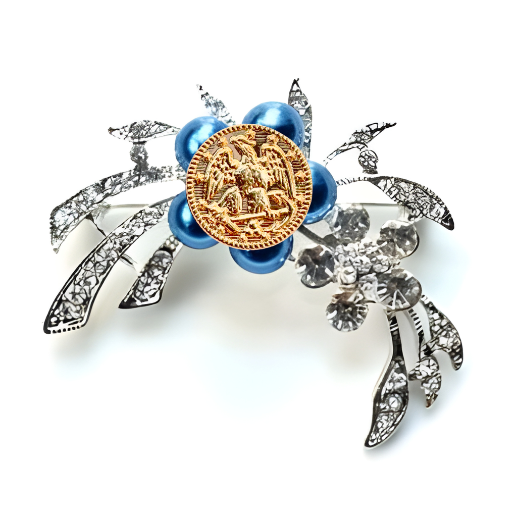 Decorative brooch with blue beads and gold center on a white background