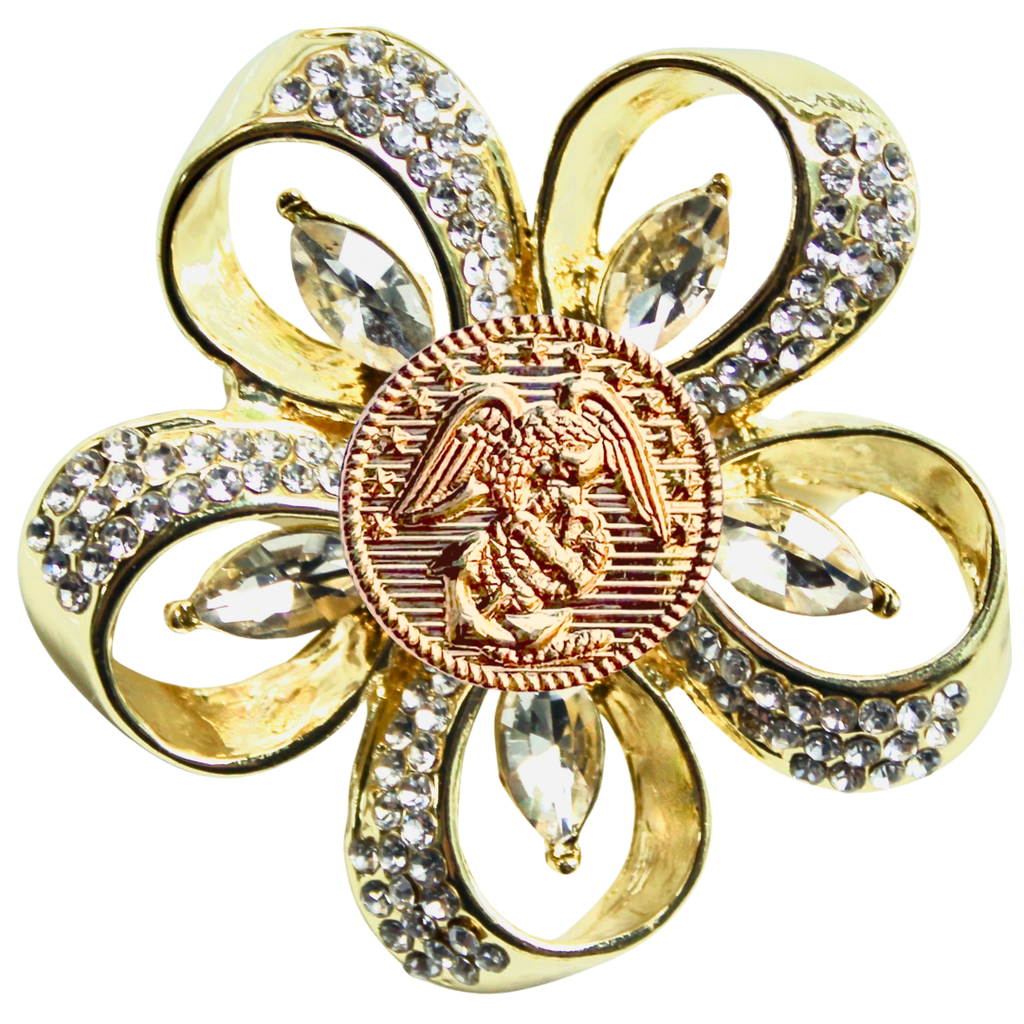 Gold brooch with crystal accents on a white background