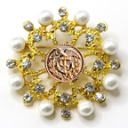 Decorative brooch with gold elements, pearls, and a Coast Guard emblem on a white background
