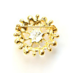 Gold brooch with a central gemstone on a white background
