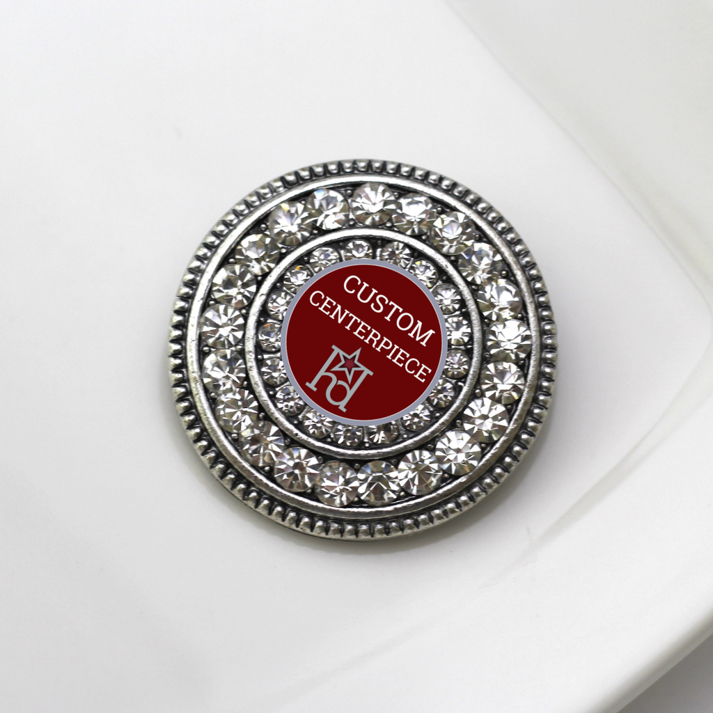 Round decorative item with crystals and red center on a white background