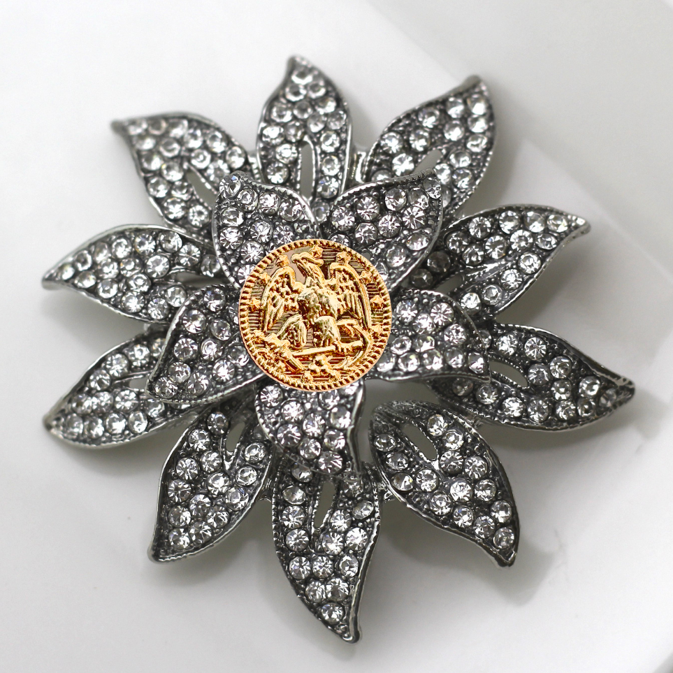 Decorative brooch with crystal details on a white background