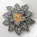 Decorative brooch with crystal details on a white background