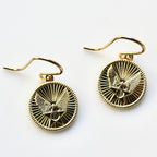 Gold earrings with an eagle design on a white background