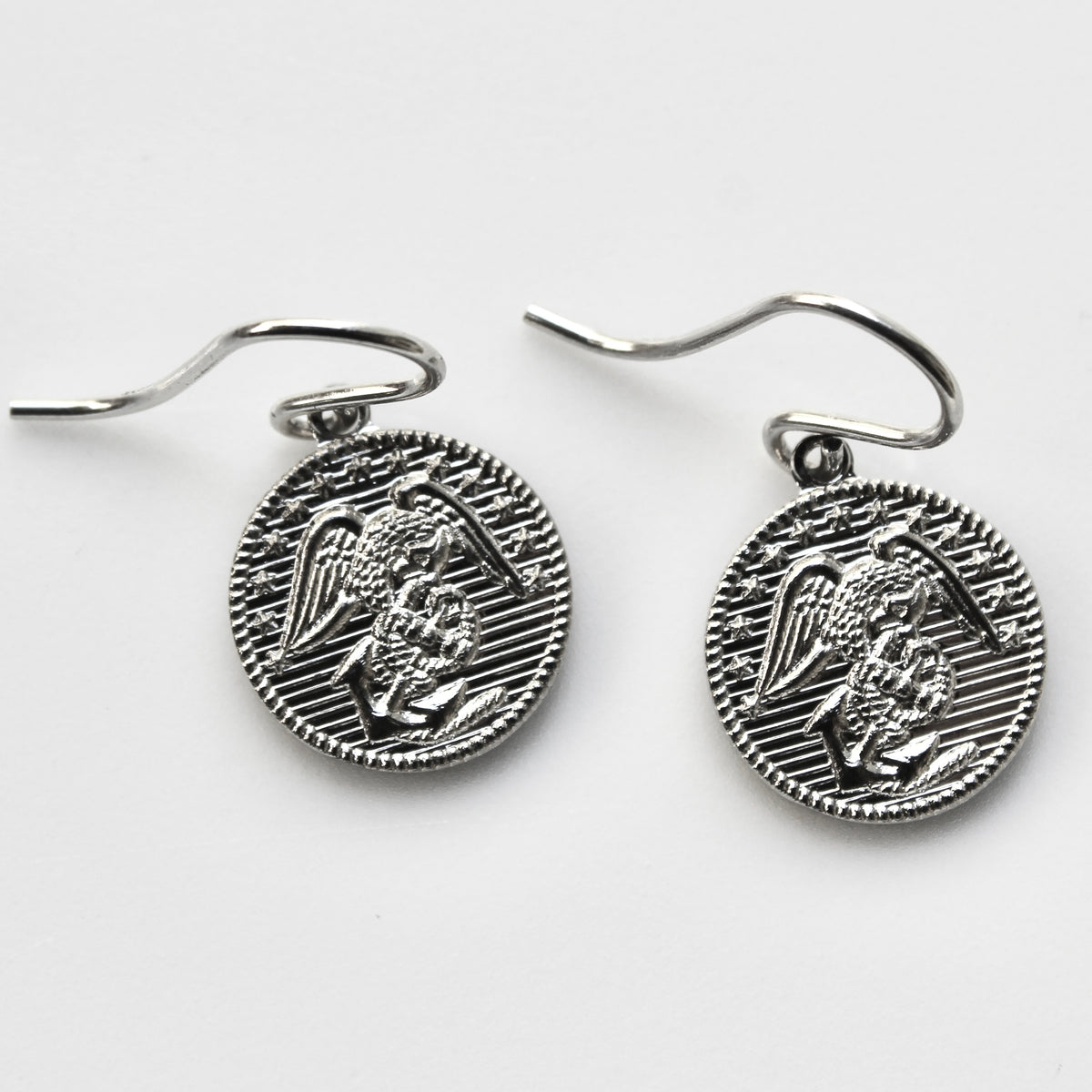 Silver angel medallion earrings on a white background
