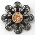 Decorative brooch with center Marines inspired gold center emblem and gemstone accents on a white background