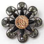 Decorative brooch with center Marines inspired gold center emblem and gemstone accents on a white background