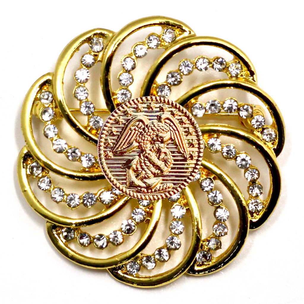 Gold brooch with gemstones and Marines inspired centerpiece on a white background