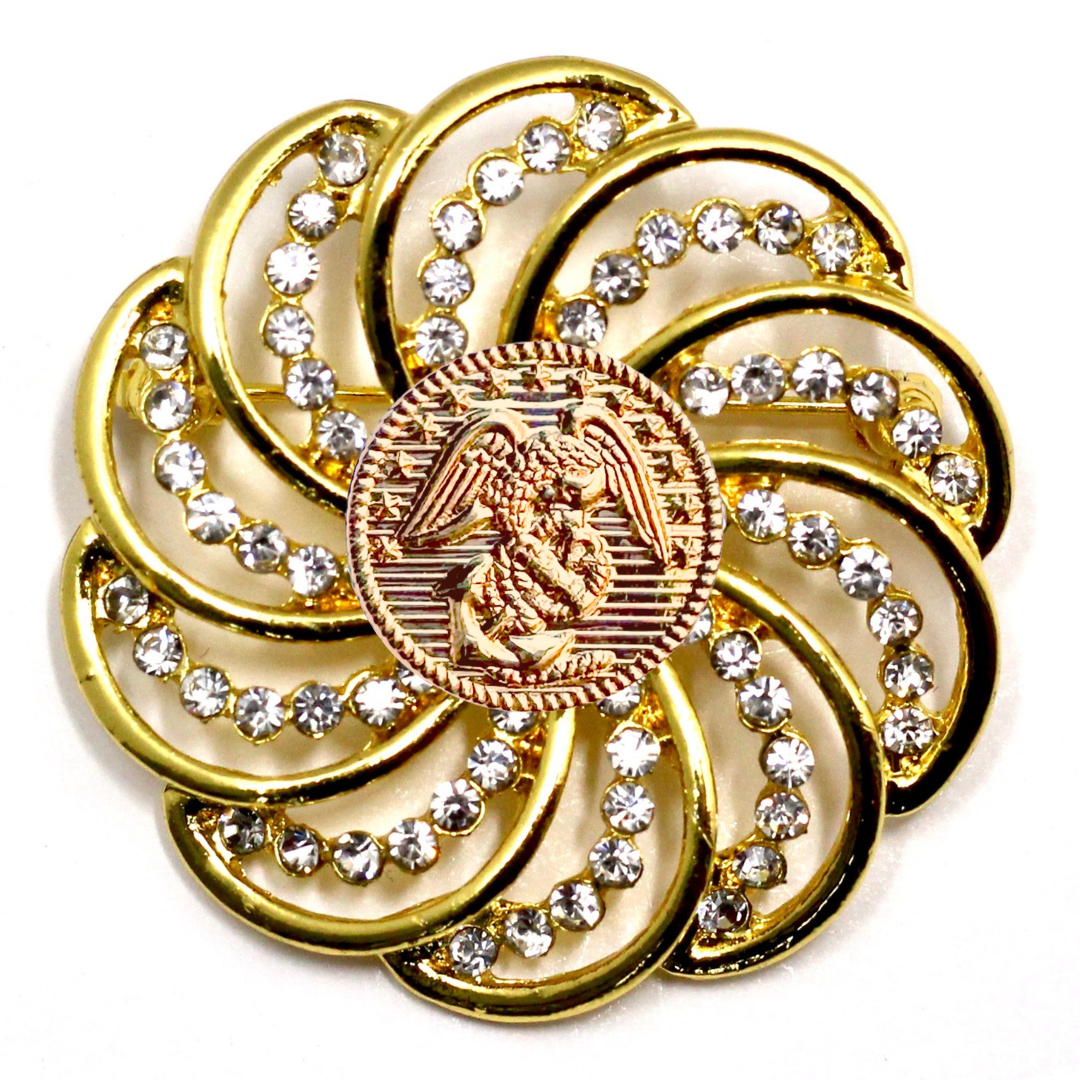 Gold brooch with gemstones and Marines inspired centerpiece on a white background