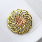 Gold brooch with gemstones and Marines inspired centerpiece on a white background