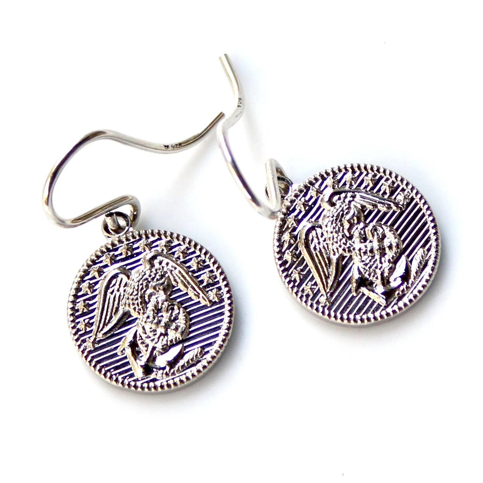 Silver angel-themed earrings on a white background