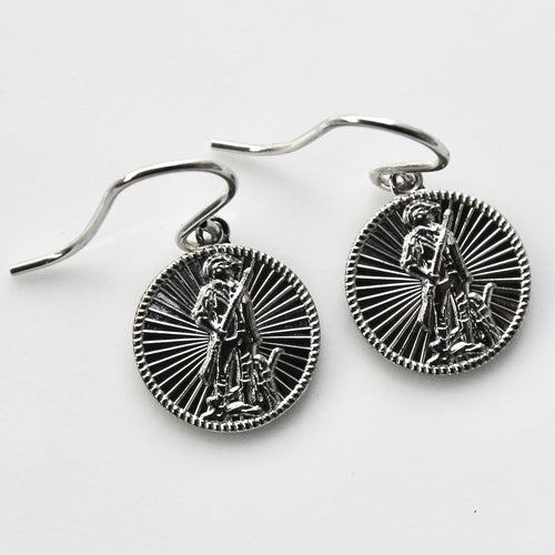 Silver earrings with detailed designs on a white background