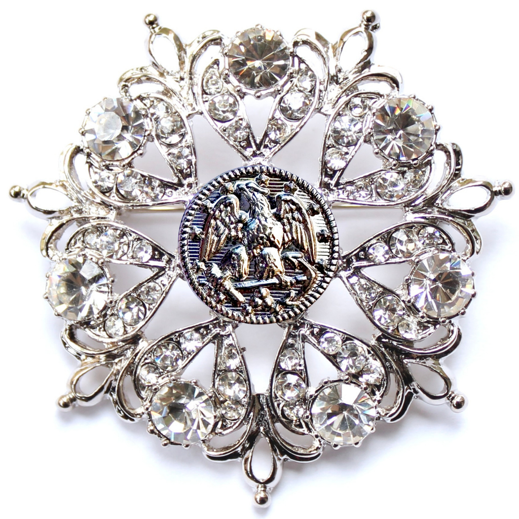 Decorative brooch with crystal-like stones on a white background