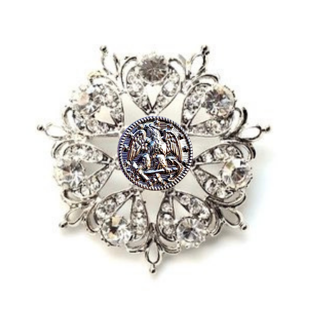 Decorative brooch with crystal-like stones on a white background