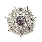 Decorative brooch with crystal-like stones on a white background
